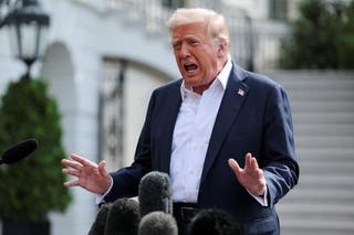 President Donald Trump talks to reporters outside the White House